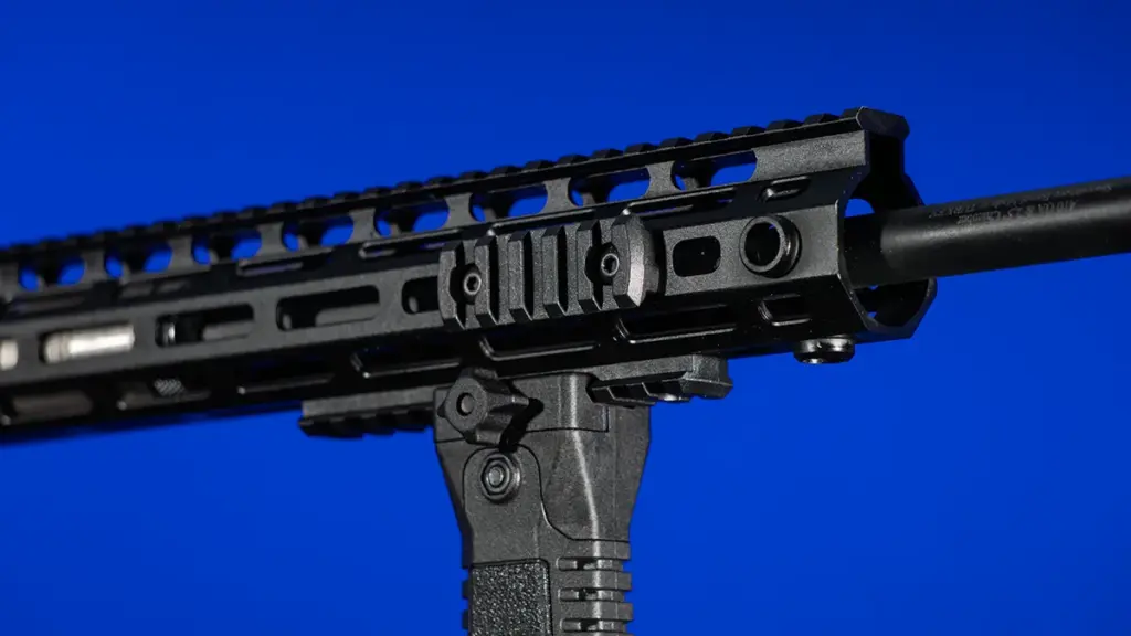 Close-up of an M-LOK foregrip attachment interface on an AR-15 handguard