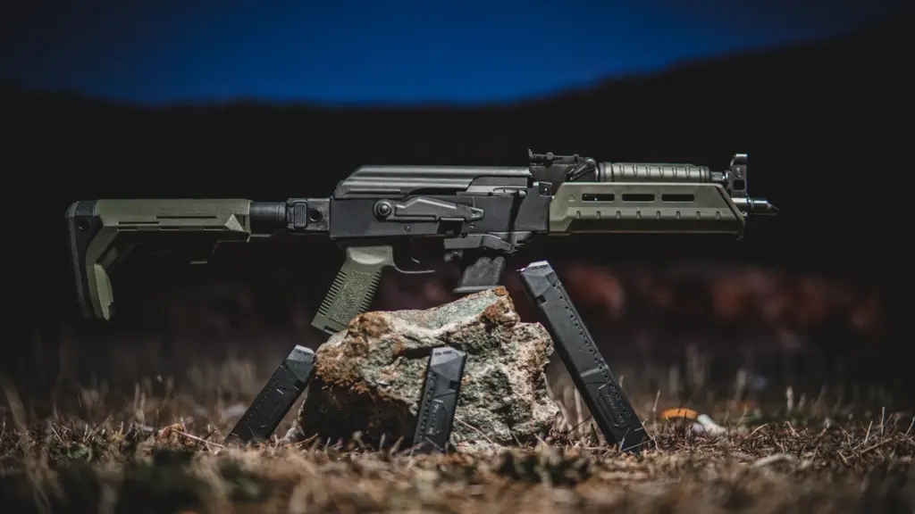 OD green AK rifle with polymer magazines at dusk